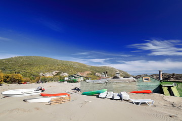 Fototapeta na wymiar Boats and plastic loungers on the sand. Patara beach-Lycia-Turkey. 1400