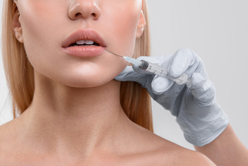 Young woman getting hyaluronic acid facial injection