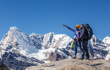 Hikers discussing travel Rout in high Mountains pointing Hand