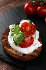 Bread with cream cheese and tomato for lunch table. Sharing anti