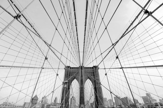 Fototapeta Perfect geometry of the Brooklyn Bridge cable web with overlook on Manhattan black and white monochrome retro photo