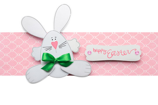 Happy easter / Creative easter concept photo of a rabbit made of paper on pink white background.