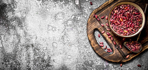 red beans in a bowl on the old Board. On rustic background.