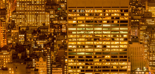 Office windows illuminated at night