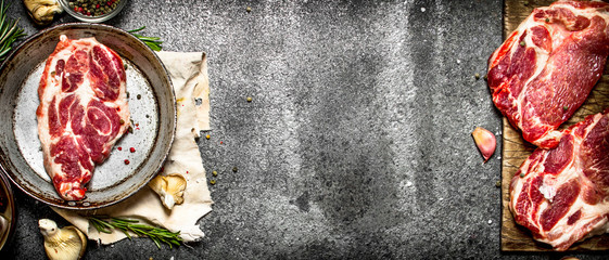 Raw meat background. Raw pork with spices and herbs.