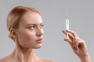 Serious lady preparing for plastic surgery