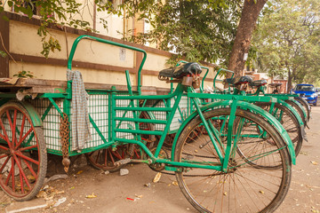 Fototapeta na wymiar View of green colored tricycle parked aside on the road, Chennai, India, Feb 19 2017