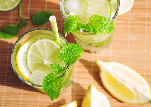 Refreshing summer drink with lemon lime mint and ice and ingredients - summer drinks overhead, top view