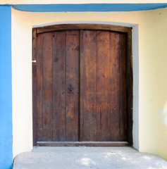 Wooden brown door with doorbell