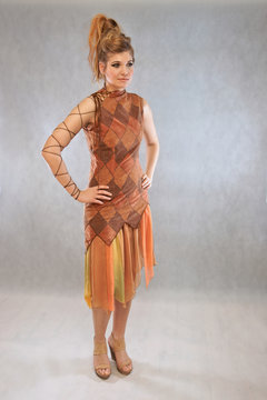 Woman in orange and brown outfit fashion studio