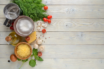 ingredients for pizza on a wooden background top view