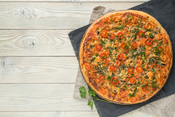 cooked pizza on a wooden background top view