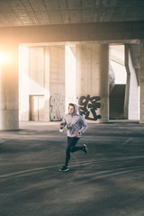 Young man running in urban environment