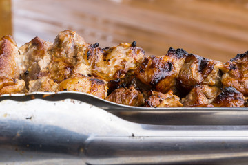 A pork skewer stick on the grill