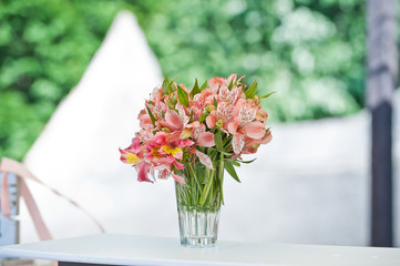 fresh flowers in vases baskets on a table decoration