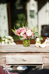 fresh flowers in vases baskets on a table decoration