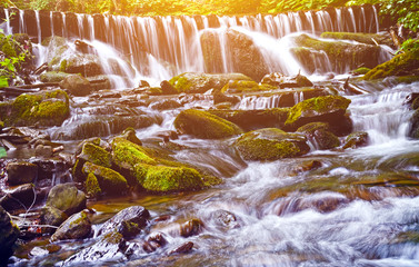 Beautiful landscape with a waterfall on the river