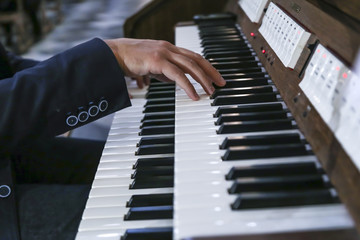Obraz na płótnie Canvas musician plays the piano; organ electric