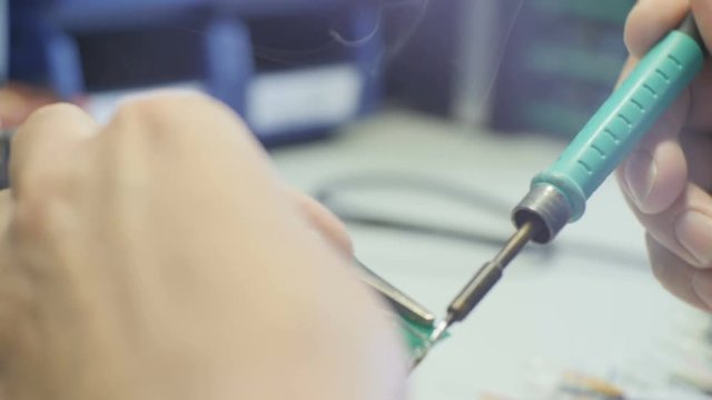 Worker Solders New Brazen Chip to Plate in Workshop