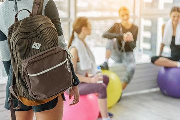 Sportive young woman with backpack