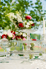 fresh flowers in vases baskets on a table decoration