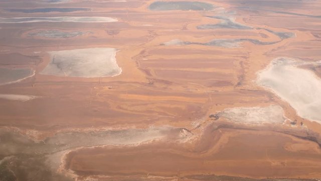 Flying over steppe with lakes and small rivers