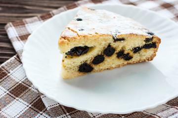 Сherry pie sprinkled powdered sugar on wooden background
