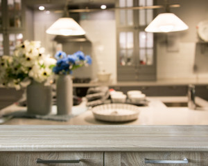 Blurred background. Modern kitchen with tabletop and space for you.