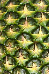 Fototapeta premium Pineapple fruit close-up. Texture of ananas pattern skin.