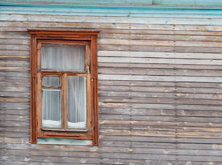 Wooden window on the old wall
