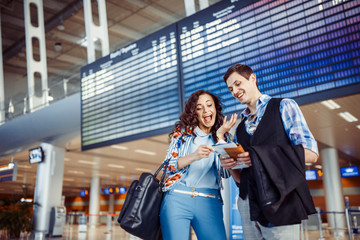 Young loving couple hugging in the airport terminal.