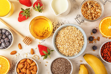 Ingredients for a healthy breakfast -  oatmeal, granola, honey, 