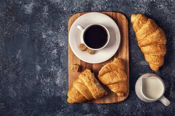 Croissants and coffee on a dark background