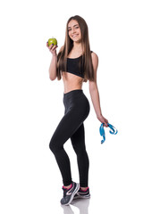 Slim and healthy young woman holding measure tape and apple isolated on white background. Weight loss and diet concept.