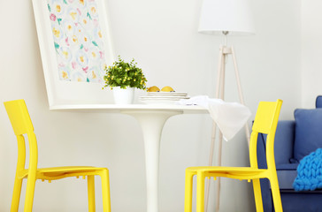Modern room interior with yellow chairs
