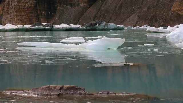 Glacial ice creaks as it melts at Upper Grinnell Lake / Grinnell Glacier in Glacier National Park, Montana.