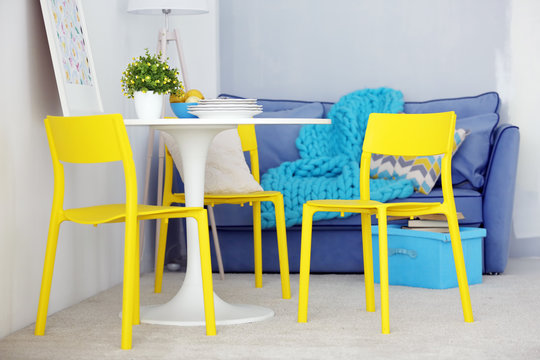 Modern room interior with yellow chairs