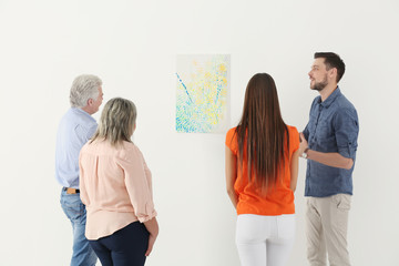People looking at picture in art gallery