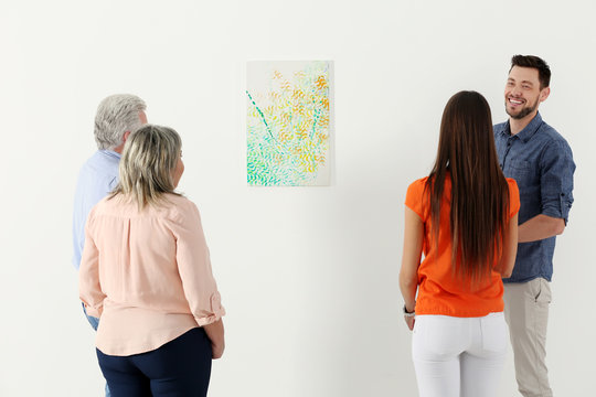 People looking at picture in art gallery