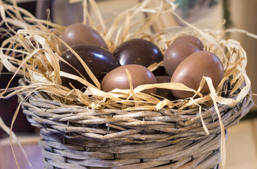 Easter Eggs of milk and dark chocolate in nest.