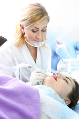 Fototapeta premium Specialist making permanent makeup in cosmetology salon