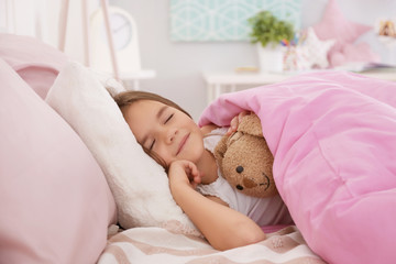 Cute little girl sleeping in bed at home
