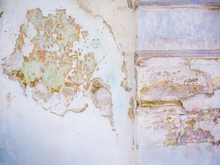 Textured old weathered wall with crumbling plaster