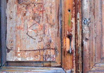 Weathered, wooden door in an old abandoned building