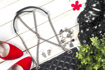 Women clothing set and accessories on white wooden background.