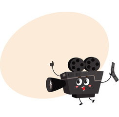 Cute and funny vintage film reel camera character with smiling human face, cartoon vector illustration with place for text. Smiling movie, cinema shooting film camera character, mascot