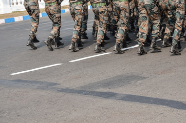 A group of military are walking with assault rifle