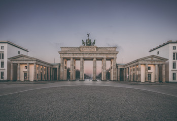 Colorful sunrise at the Brandenburg Gate in Berlin, Germany in February, vintage filtered style