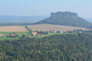 Naklejka premium View on fields, villages and farms from Festung Konigstein fortress, Saxon Switzerland, Bavaria, Germany. Famous tourist and travel routes. Natural lighting.
