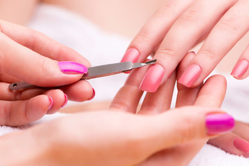 Obraz na płótnie Canvas Woman hands during manicure session